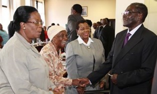 President Mugabe greets (from left) Cdes Olivia Muchena, Victoria Chitepo and Ednah Madzongwe on arrival for a Politburo meeting at Zanu-PF Headquarters in Harare yesterday.