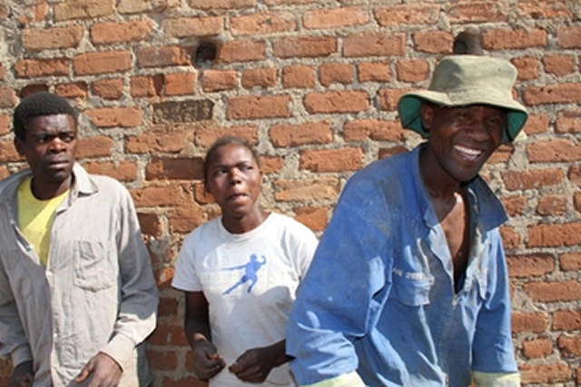 Enetty Midzi at her home in Magunje, Hurungwe, the polyandrous woman with her two husbands — Chamunorwa Ruramai (left) and Samuel Tsaramba