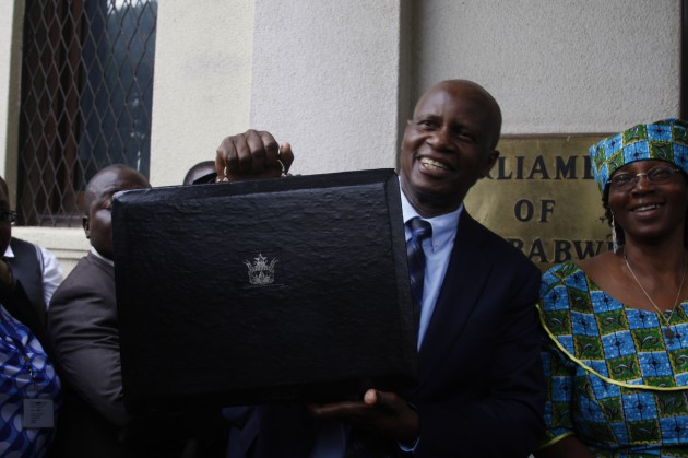 Minister Chinamasa arrives to present the 2014 National Budget accompanied by his wife Monica