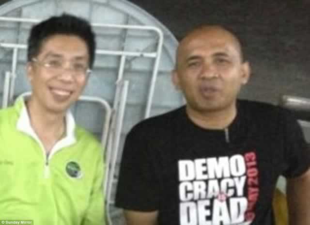 Peter Chong (left) with best friend Captain Zaharie Ahmad Shah, pilot of the missing Malaysia Airlines plane. He is pictured in a T-shirt with a Democracy is Dead slogan as police investigate claims he could have hijacked the plane as an anti-government protest. – Daily Mirror/MailOnline.