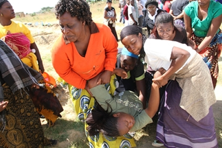 Mrs Leona Kiti, the mother to Tanatswa Neil Mutyora who was knocked down by a commuter omnibus, being carried away by mourners after collapsing at her son’s grave at Granville Cemetery in Harare yesterday. —(Picture by Justin Mutenda)
