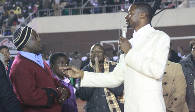 Pastor Makandiwa prophesing to some of the attendees. - (picture by Munyaradzi Chamalimba).
