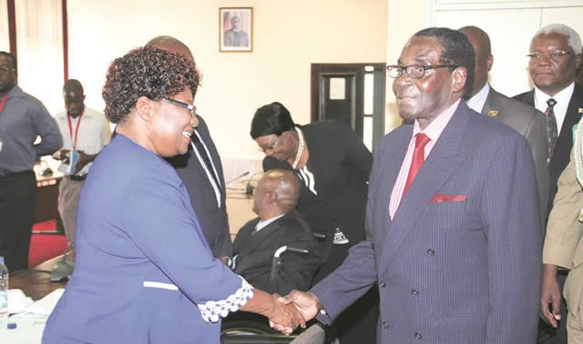 President Mugabe greets zanu-pf secretary for Gender and Culture Cde Thokozile Mathuthu on arrival for the revolutionary party’s Politburo meeting in Harare yesterday