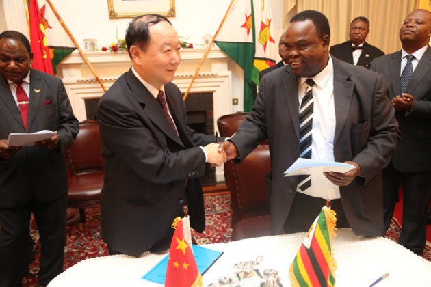AVM Africa Ltd group executive chairperson, Mr Kenneth Musanhi shakes hands with Baic Automative Group president, Mr Fengli Guo at State House on Tuesday after signing a Joint venture agreement .