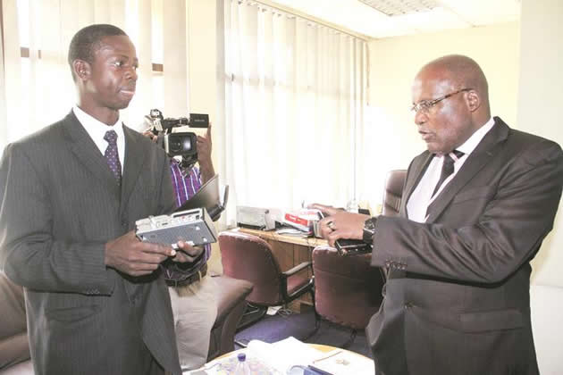 Information, Media and Broadcasting Services Minister Dr Christopher Mushohwe is shown a set top box by Broadcasting Authority of Zimbabwe chief executive officer Obert Muganyura during a tour of BAZ offices in Harare yesterday.