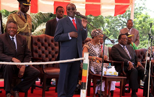 President Mugabe addresses zanu-pf supporters ahead of a Politburo meeting at the party’s headquarters in Harare yesterday as the First Lady Amai Grace Mugabe, who is also the Women’s League secretary and Vice Presidents Cdes Emmerson Mnangagwa and Phelekezela Mphoko (left) follow the proceedings 