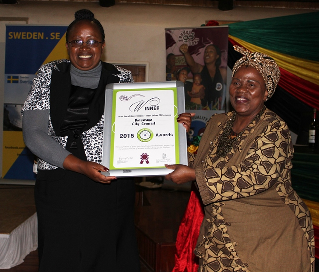 Gender and Community Development Deputy Minister Abigail Damasane (right) poses for a photo with Bulawayo City Council gender focal person Audrey Manyemwe after the latter won award at the Zimbabwe National Gender Summit held in Harare last year