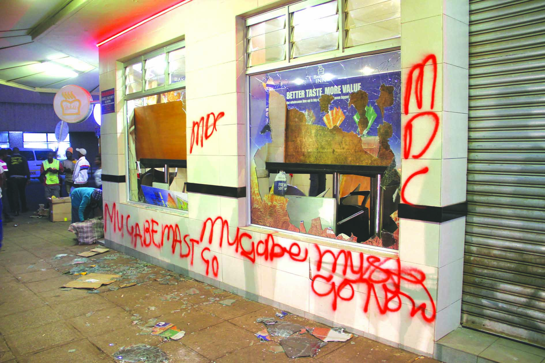 Political graffiti by opposition elements on the walls of a vandalised fast-food outlet in the capital