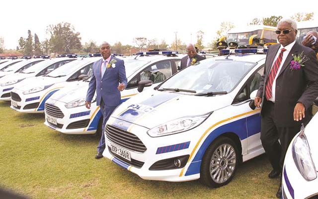 Minister of Home Affairs Dr Ignatius Chombo (right) and Commissioner-General Augustine Chihuri look at some of the ZRP operational vehicles during commissioning in Harare yesterday. — (Picture by Innocent Makawa)