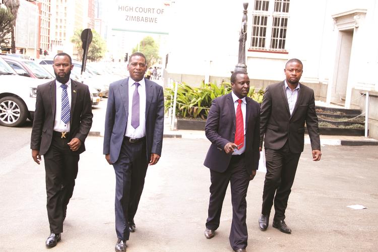 Citizens Against Violence and Anarchy Trust chairperson Faustino Mazango (second from left), flanked by members of the trust (from left) Joy Sadiki,Elton Ziki and Takudzwa Mutumbwa arrive at the High Court in Harare yesterday to file their papers against National Elections Reform Agenda members who triggered violence in August. — (Picture by Justin Mutenda)