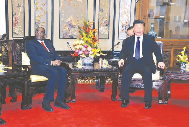 President Mugabe meets his Chinese counterpart Xi Jinping in Beijing yesterday. — (Picture by Presidential Photographer Joseph Nyadzayo)