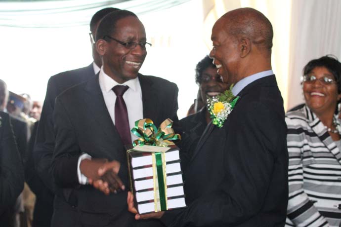 Chief Justice Chidyausiku hands over the Judicial Service Commission Law Reports to Professor Lovemore Madhuku.