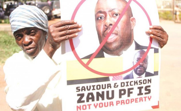 Mbuya Emely Gweu (left) carrying one of the posters