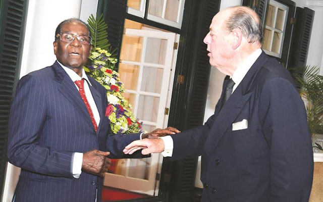 President Mugabe welcomes the Right Honourable Sir Nicholas Soames (MP), son to former Governor of Rhodesia Lord Soames, when he paid a courtesy call at State House in Harare on Wednesday. — (Picture by Presidential Photographer Joseph Nyadzayo)