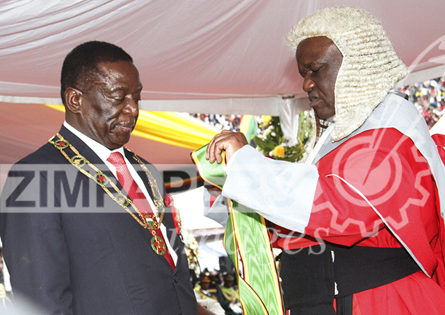 President Emmerson Mnangagwa being adorned with his sash by Chief Justice Luke Malaba soon after his inauguration in Harare this afternoon. Picture by John Manzongo