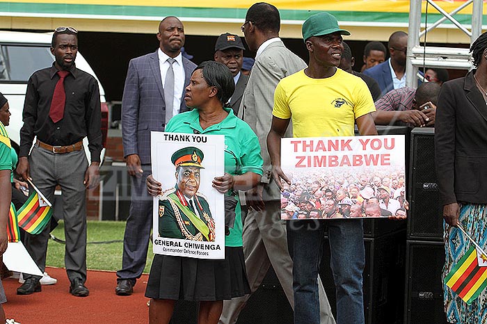 A woman holds the portrait of Commander Zimbabwe Defence Forces General Constantine Chiwenga during the inaguration of President ED Mnangagwa at the National Sports Stadium, 24 November 2017. - Wilson Kakurira