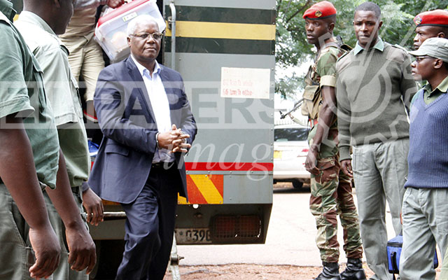 Former Minister of Finance Dr Ignatius Chombo being escorted into Harare Magistrates court under heavy security from Military police and prison officers during his bail ruling yesterday. Picture by John Manzongo